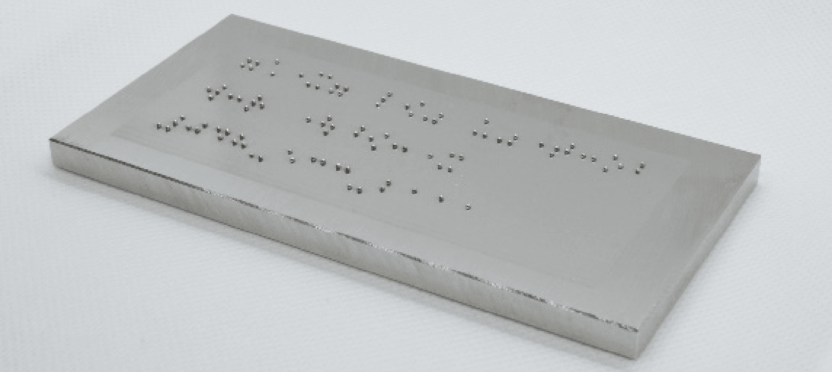 Metal Braille dot characters that are resistant to deterioration over time